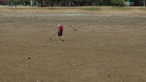 Man-with-Metal-Detector-Hunting-for-Teasure-in-La-Sabana-Park