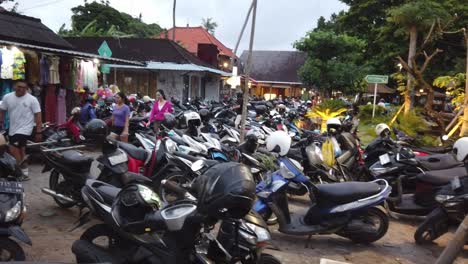 Parking-Scooters,-People-Walk-at-Sindhu-Beach,-Sanur-Bali-Indonesia-Typical-Market-Pathwalk-in-Denpasar,-Local-Clothing-Stores