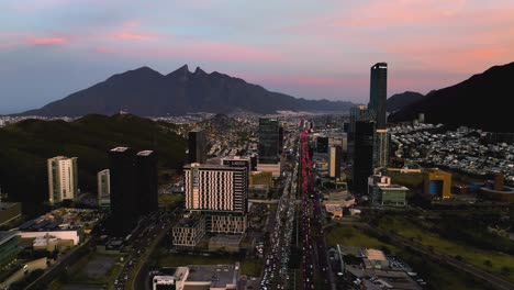 Aerial-view-approaching-traffic-on-Highway-85-in-the-San-Pedro-Garza-Garcia,-Monterrey,-dusk-in-Mexico