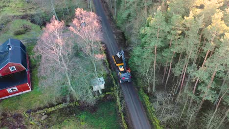 Aerial-view-of-heavy-machine-digging-a-ditch-by-forest-road