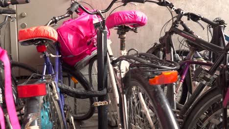 Left-rotation-around-Foodora-food-delivery-bikes-parked-in-urban-setting