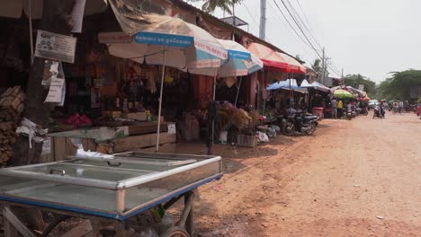 Locals-on-typical-street-market-next-to-Siem-Reap-in-Cambodia,-Asia