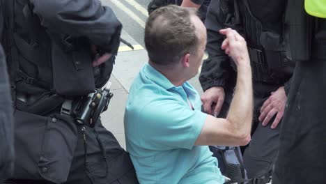 A-Tommy-Robinson-supporter-is-knocked-to-the-ground-whilst-being-arrested-along-Whitehall,-London