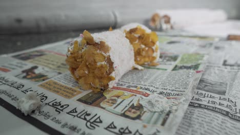 Swill-roll-making-with-mixing-of-cornflakes-by-an-old-man-in-bakery-close-shot