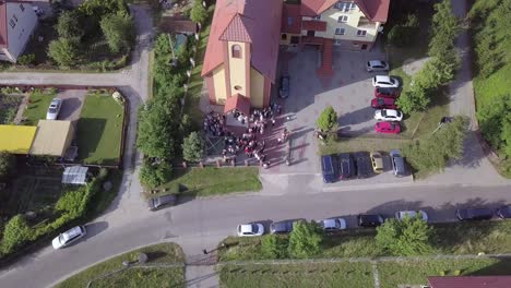 Aerial-shot-of-a-wedding-ceremony-in-a-small-church-on-a-coutryside