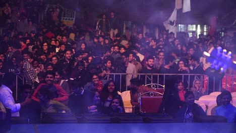 College-students-cheering-during-a-concert-in-their-college