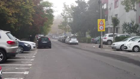 Bucharest,-Romania---October-:-Walking-on-the-foggy-street-of-Bucharest,-walk-on-the-alley-in-the-morning,-autumn-season