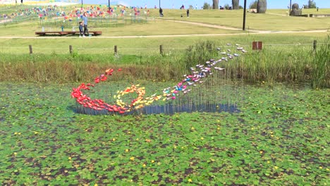 A-mother-and-a-son-walk-by-a-pond-at-Imjingak-by-the-DMZ-overlooking-North-Korea,-in-Munsan,-Paju,-Gyeonggi-do,-South-Korea