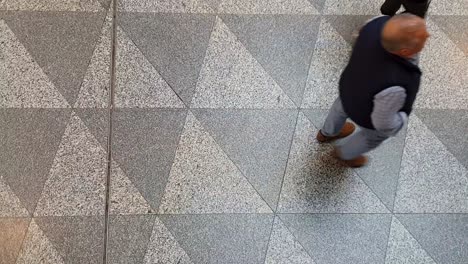 Busy-airport-hallway,-zoomed-in-top-down-perspective