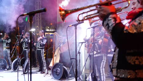 Camera-booms-up-showing-a-mariachi-ban-on-stage-at-night