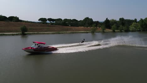 Aerial-footage-of-a-woman-water-skiing-behind-a-fast-boat-in-Monaco