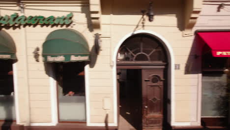 View-from-window-of-bus-pass-by-street-restaurants-and-shops