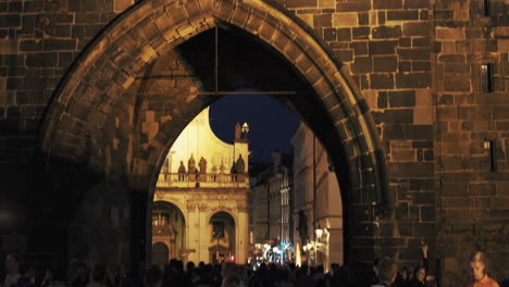 Tower-of-Charles-Bridge-in-old-town-at-night-Tourist-walking-and-sightseeing-Prague,-Czech-Republic-4K