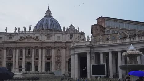 Rainy-day-with-umbrellas-in-front-of-Saint-Peter-square-and-cathedral-basilica-in-Vatican-city-center-in-Rome,-Italy