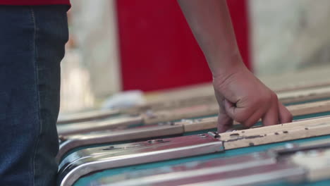 Hand-grabbing-ball-from-Skee-Ball-machine-at-carnival-game,-Slow-Motion