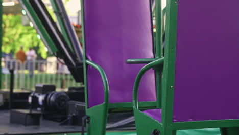 Empty-carnival-ride-seat-swinging,-Close-Up,-Slow-Motion