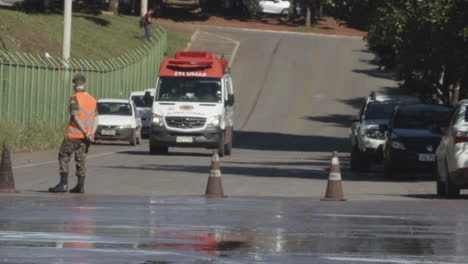 Ambulance-arrives-at-hospital,-Brazilian-military-personnel-controlling-the-area