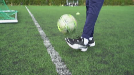 Jugador-De-Fútbol-Negro-Hace-Malabarismos-Con-Una-Pelota-En-Un-Campo-De-Fútbol