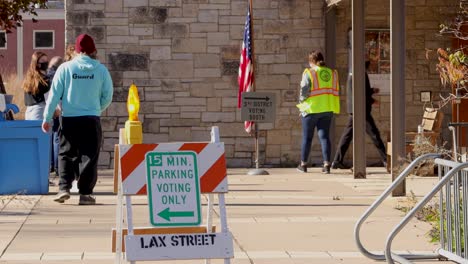 A-small-line-outside-an-in-person-voting-location-as-voters-in-line-are-slowly-let-inside-while-practicing-social-distancing-and-wearing-masks-during-the-COVID-19-Pandemic