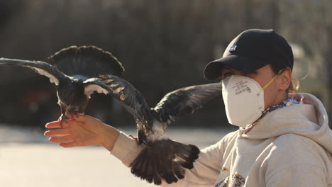 Female-With-Protective-Face-Mask-and-Pigeons,-Covid-19-Virus-Outbreak-Concept