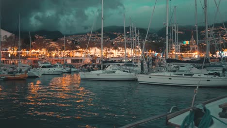 Vista-Trasera-Del-Marinero-Navegando-Hacia-El-Club-Náutico-De-Madeira-Marina-Por-La-Noche