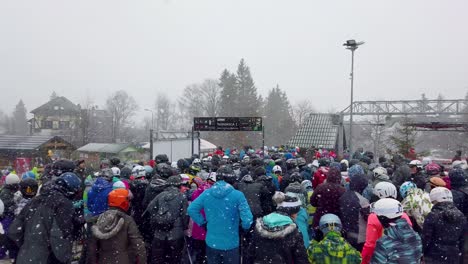 Crowds-of-tourists-and-skiers-queuing-up-to-the-Szrenica-mountain-chairlift-in-Szklarska-Poreba-resort-during-winter-school-holidays,-Karkonosze-mountains,-Poland