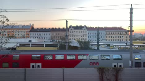 Various-scenes-of-commuter-trains-passing-in-front-of-buildings-in-the-city-of-Vienna,-Austria