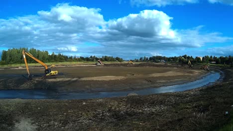 Excavators-are-working-with-Buckets-to-Clear-Mud-Sludge-and-Debris-from-the-Bottom-of-the-Drained-River