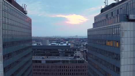 Slow-whip-pan-with-drone-of-apartment-buildings-and-the-city-skyline-of-Stockholm-in-the-background-at-sunset