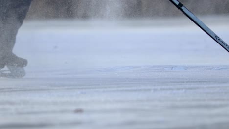 A-slow-motion-of-a-puck-sliding-on-ice-out-of-focus-towards-camera