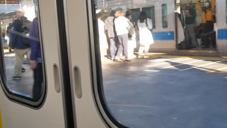 Landscape-view-of-the-train-door-from-inside-the-train-while-train-is-leaving-from-the-station-in-Tokyo-City-4K-UHD-video-movie-footage-short