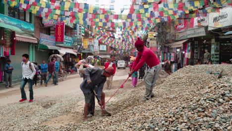 Man-shoveling-stones-into-a-basket-on-another-mans-back