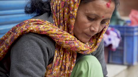 Medium-shot-of-Woman-Preparing-Merrigold-Necklaces-at-the-street-market-in-Kathmandu,-Nepal