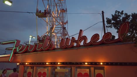 Ferris-wheel-Sign-and-ride-in-the-evening