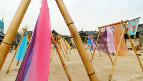 colorful-hanbok-fabric-hanging-on-traditional-korean-hanoaks-in-namsangol-hanoak-village