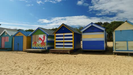 Tourists-walking-and-taking-photo-at-Brighton-Bathing-Boxes,-Melbourne,-Australia