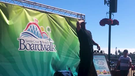 Man-performing-with-the-knife-at-Santa-Cruz-Beach-boardwalk-in-California,-United-States