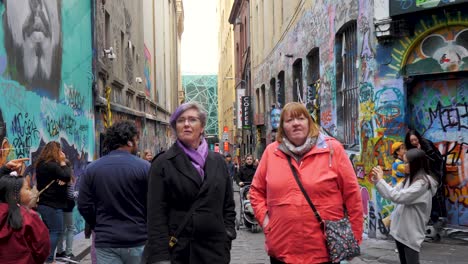 Tourists-visiting-graffiti-artwork-in-Hosier-Lane-Melbourne-CBD