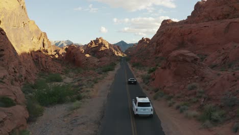 Weiße-Rolls-Royce-Und-Schwarze-Ferrari-Fahren-Durch-Die-Schluchten-Des-Valley-Of-Fire,-Nevada