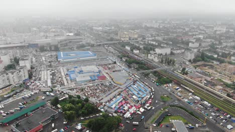 Aerial-View-of-Industrial-Center-Next-to-Railroad-Tracks-in-a-City-on-a-Foggy-Day