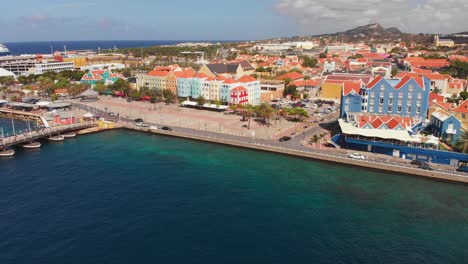 Amazing-aerial-of-Queen-Emma-Bridge-in-Sint-Anna-Bay-with-a-cruise-ship-docked-in-the-background