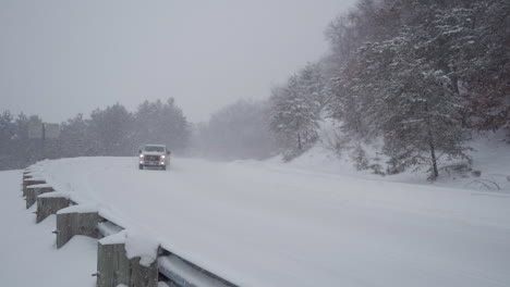 A-pickup-truck-drives-through-heavy-snow-on-a-rural-Wisconsin-road-in-slow-motion