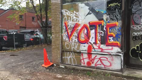 Vote-Graffiti,-Kensington-Market,-pan