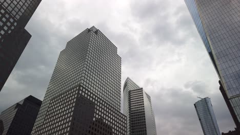 Modern-skyscrapers-with-glass-facades,-Manhattan,-NYC-business-and-financial-district,-sky-reflecting-from-windows