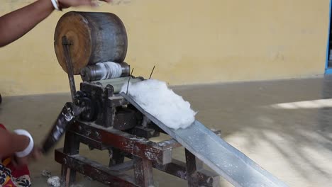 Rural-poor-Indian-women-spinning-yarn-at-cottage-industry-to-make-cotton-thread-out-of-raw-cotton,-small-scale-industry