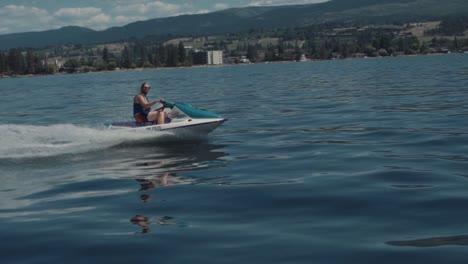 Man-Riding-a-Jet-Ski-and-Having-Fun-on-the-Lake