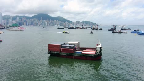 Small-Feeder-class-Container-ship-in-Hong-Kong-bay,-Aerial-view