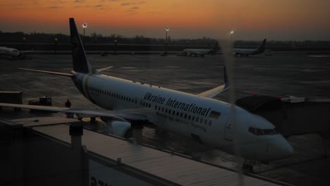 Passenger-planes-parked-by-the-runway-of-the-Boryspil-International-Airport,-Ukraine---time-lapse