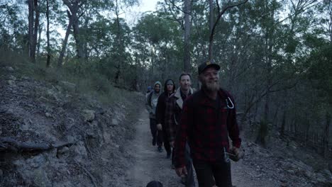 Group-Of-Men-Carrying-A-Long-And-Thick-Rope-While-Walking-On-The-Trail---Mount-Byron-Walking-Track---Queensland,-Australia