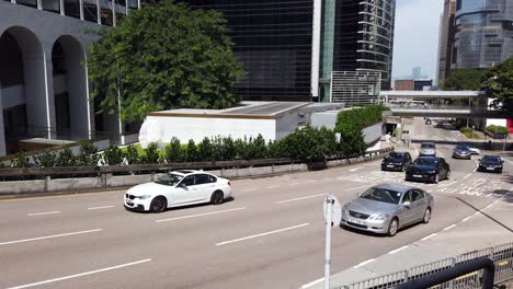 Traffic-passing-in-downtown-Hong-Kong,-Low-angle-aerial-view